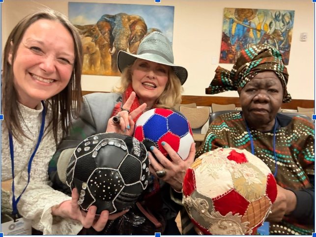 Sarah Noet, Cat Schuller and Queen Mother Dr. Deloris Blakely holding three hand-stitched fabric Unity Balls at the United Nations.